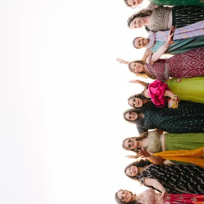 The bride's squad, full of energy and joy. This fun, low-angle shot captures the excitement and support of the bridesmaids, a key part of the wedding celebration.