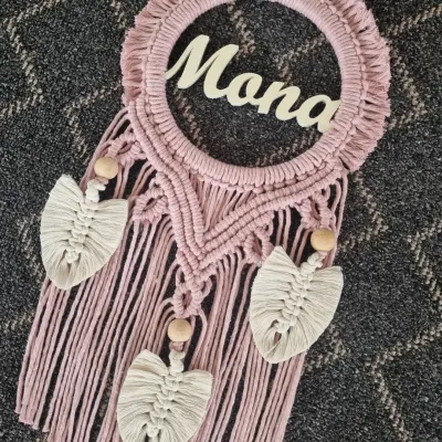 A name etched in time. This dusty rose macrame wall hanging, personalized with the name 'Mona', is a beautiful symbol of love and makes for a treasured personal gift.