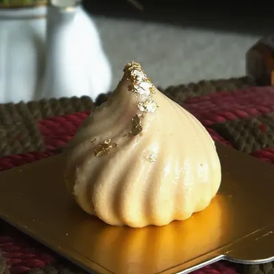 This is my Cheesecake Modak, a special creation for the Ganpati festival. It has a creamy, tangy cheesecake filling encased in a modak-shaped shell, finished with a touch of edible gold leaf. It's my modern prashad to Bappa.
