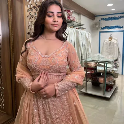 A lovely peach-colored lehenga with all-over silver embroidery. This pre-loved piece is elegant and perfect for a daytime wedding or engagement.
