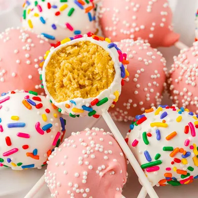 A colourful pile of cake pops from one of my dipping events. Participants get to dip their own cake pops in white or pink coating and decorate them with rainbow and pearl sprinkles.
