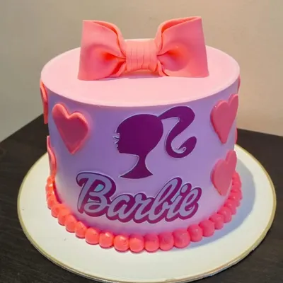Come on Barbie, let's go party! This fabulous Barbie-themed cake, with its signature pink bow and silhouette, is perfect for the ultimate Barbie fan's birthday.