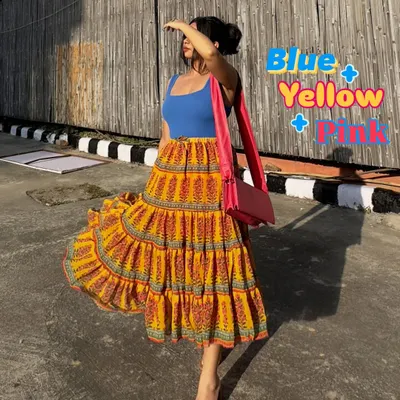 A perfect summer color combination for my brown girlies: blue, yellow, and pink. This vibrant tiered skirt paired with a simple blue tank top and a pink bag is a great example of joyful color blocking.