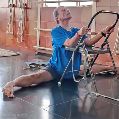 A demonstration of Hanumanasana (splits) using a chair, filmed for an online class. Props make even advanced poses more accessible when practicing from home.