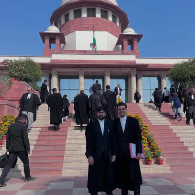 On the steps of the Supreme Court of India with a colleague. Practicing here is a privilege and a responsibility we take very seriously.