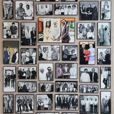 A closer look at the impressive 45-photo gallery wall we created for Kiran Gems. Each photograph is perfectly aligned and spaced, creating a seamless and powerful visual timeline of the company's history and achievements.