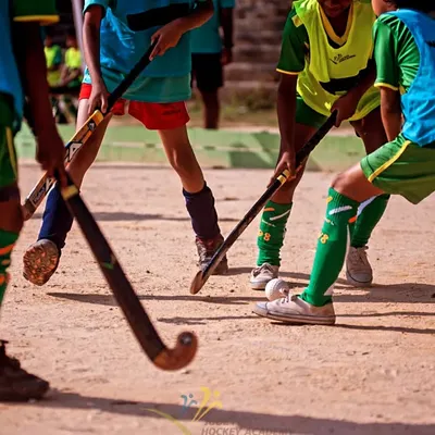 The clash of sticks on a dirt field. This image captures the essence of grassroots hockey, where the love for the game is all that matters.
