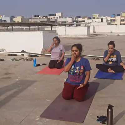 An early morning rooftop session focused on Pranayama, or yogic breathing. Practicing these controlled breathing techniques in the open air is incredibly beneficial for lung capacity and mental clarity.