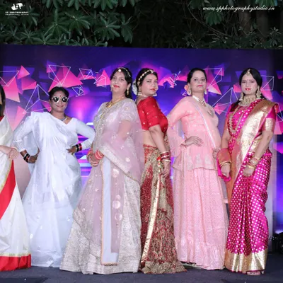 We cover corporate cultural celebrations and performances. This group of women in traditional attire poses on stage, showcasing a festive moment from a company event.