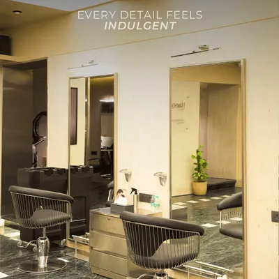 Every detail in our salon is designed to feel indulgent. The men's section features modern styling chairs and clean lines for a sophisticated grooming experience.