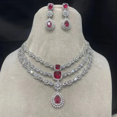 This is a stunning three-layer American Diamond necklace with ruby-red stones. It's a perfect rental piece for a grand reception or cocktail party.