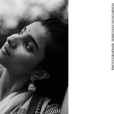 From my personal series 'Rafta', this black and white portrait captures a quiet, contemplative moment. The soft, natural light highlights the model's profile and the traditional jhumka earring, creating a timeless and soulful image.