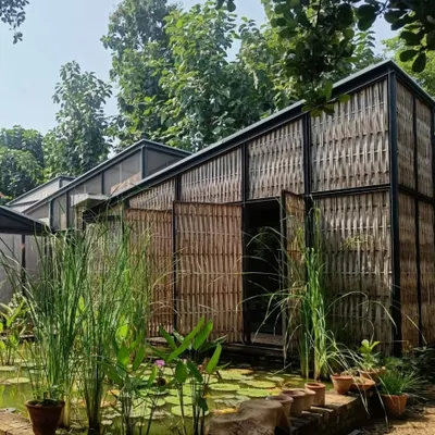 The Artist Residency at Farm8, where a bamboo exoskeleton is woven onto a lightweight steel frame. The structure sits beside a lily pond, creating a conversation between the natural landscape and the man-made form, which is built from sustainable, organic materials.