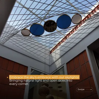 This skylight at the Gopal Residence is a centerpiece of the design. The suspended blue and white discs interact with the sunlight, creating a celestial effect while bathing the double-height space in a soft, diffused glow.