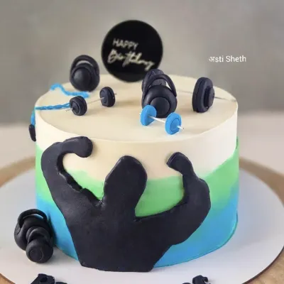 A cake for a fitness enthusiast, featuring a weightlifter silhouette and fondant dumbbells. The blue and green watercolour effect adds a modern touch.