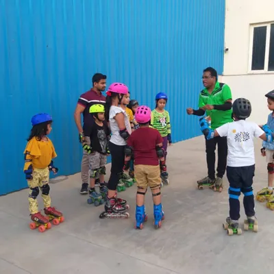 A young group of skaters listening to instructions before practice. I make sure every child is equipped with proper safety gear like helmets and knee pads before we start any session on the court.