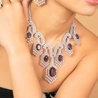 A full look at our American Diamond necklace set with amethyst-colored stones. The set includes a matching bracelet, offering a complete, coordinated look for a modern event.