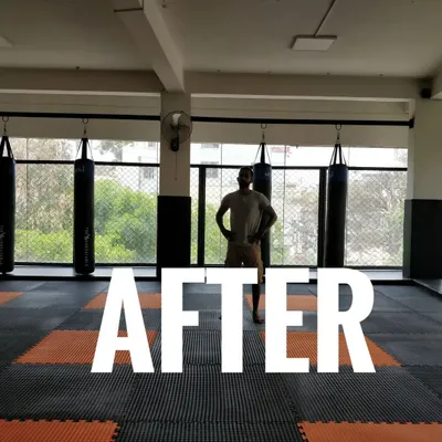 This is the 'after' shot. A look at our fully equipped training facility, complete with matted floors, punching bags, and a cage wall, ready for serious training.
