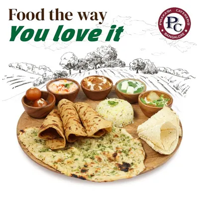 I prepare food the way you love it. This image showcases a classic North Indian thali with an assortment of breads like naan and roti, flavourful curries, rice, and a sweet gulab jamun to finish.