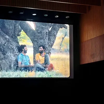 A scene from the film 'Sabar Bonda' projected onto the large screen of our auditorium. This shot gives a viewer's perspective of the high-quality cinematic experience we offer.