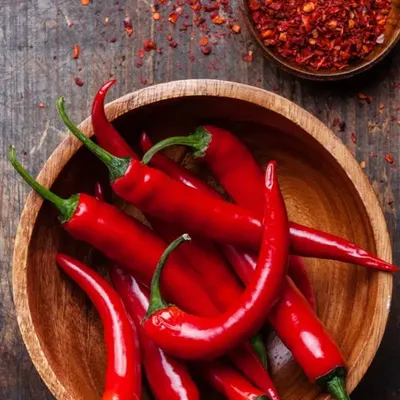 The vibrant, fiery red of fresh chillies can inspire a bold accent wall in a kitchen or dining room, bringing energy and warmth to the space.