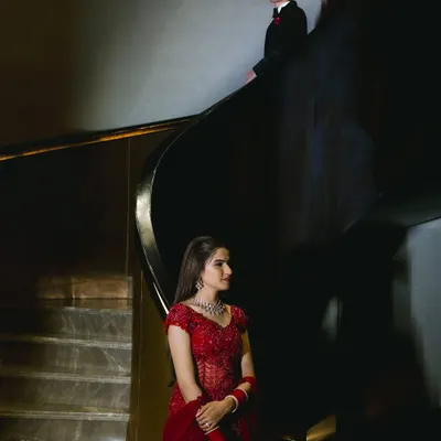 A cinematic shot from a pre-wedding shoot where my makeup played a key role. For the bride, I created a glamorous look with a bold red outfit, focusing on flawless skin and defined features that would stand out in this dramatic, beautifully lit setting.