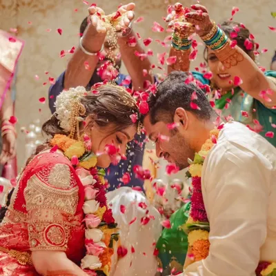 A beautiful, emotional moment from a wedding ceremony, with the couple being showered in flowers. It's moments like these that make everything worthwhile.
