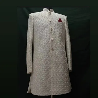 A classic off-white sherwani, perfect for a groom. I focus on getting the details right, from the intricate self-patterned fabric to the structured, clean tailoring that guarantees a royal look.