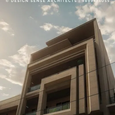 An upward view of a residential building we designed, showcasing its strong geometric lines and modern form. The play of solid and void creates a dynamic facade that changes with the light and shadows throughout the day.
