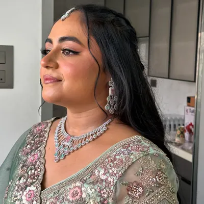 Vrushali looking absolutely radiant for her engagement. We went for a soft glam look with a focus on glowing skin and beautifully defined eyes to complement her pastel green lehenga.