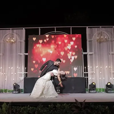 The classic dance dip! We love capturing the peak moments of a couple's Sangeet performance against a beautifully lit stage.