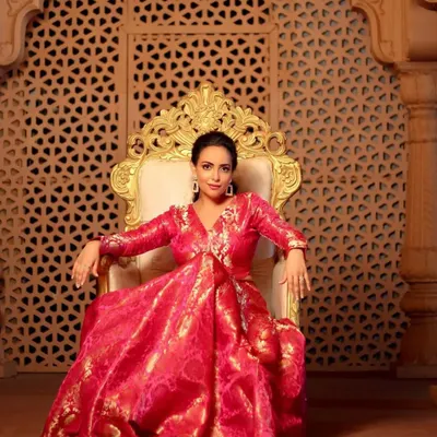 A regal portrait of Aanchal Munjal for a Diwali shoot. The makeup is luminous and festive, with a pulled-back hairstyle that keeps the focus on her radiant face and the stunning pink brocade outfit.