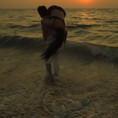 A classic moment from a sunset engagement shoot, with the warm light of the setting sun creating a beautiful silhouette. This is the kind of cinematic couples photography I love to create by the sea.