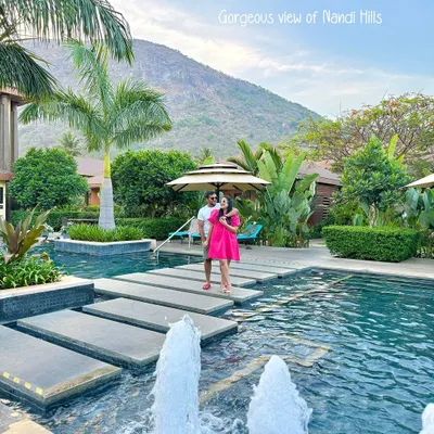 A couple enjoys the stunning view of Nandi Hills from across our pool. The stepping stones over the water create a picturesque path, perfectly framing the natural landscape that makes this retreat so special.