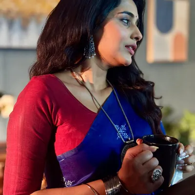 A profile shot of the actress on set, showcasing how the makeup holds up from every angle. The soft contouring and natural lip color define her features for the camera.