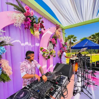 A clear view of my DJ and percussionist setup at a beautiful outdoor wedding function. The combination of my mixing and live drumming creates a full, dynamic sound perfect for daytime celebrations.