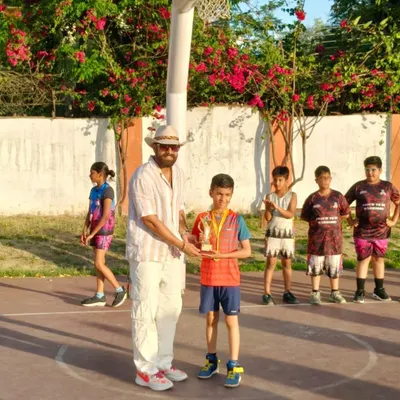 Presenting a trophy to a deserving player at the 3x3 Basketball Tournament. Recognizing individual excellence is a key part of my events.