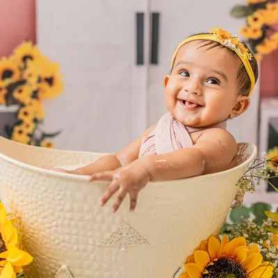 A cheeky grin from the tub. This sunflower-themed milk bath session was so much fun, and she absolutely loved splashing around.
