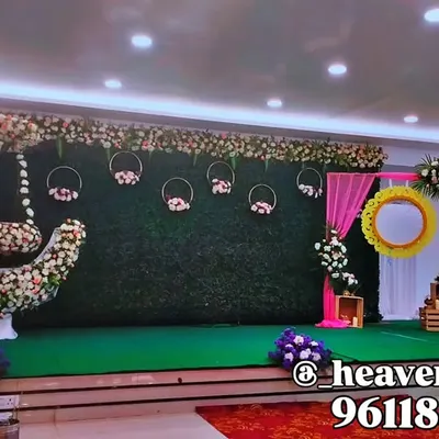 A popular design for naming ceremonies, this setup features a floral crescent moon swing against a lush greenery wall. The hanging baskets and decorative mirror add whimsical touches to welcome the new baby.