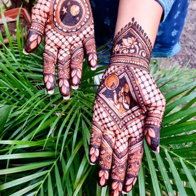 A beautiful Karwa Chauth design featuring the traditional scene of a woman looking at the moon through a sieve. The other hand has a celestial moon and stars pattern.