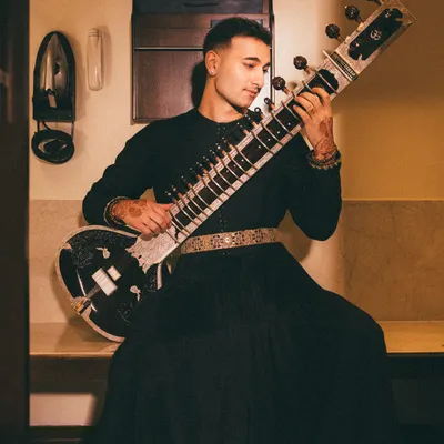 A portrait embodying my 'Sitar Sorcerer' persona. This look, in a custom Torani outfit, captures the magic and mystery I aim to bring to my music.