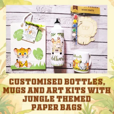 Here is a complete jungle-themed hamper, featuring a personalized water bottle, a matching mug, and a creative woodcraft art kit, all presented in a custom paper bag.