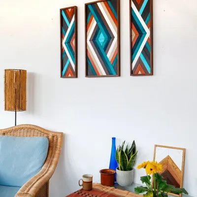 Our three-piece boho wooden mosaic set hung above a console table. The vibrant colors and geometric patterns add a playful and artistic touch to this eclectic space.