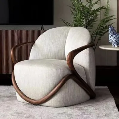 A truly sculptural piece, this accent chair features a unique, flowing teakwood frame that wraps around a plush, upholstered seat. It's a work of art that provides comfortable seating, perfect for making a statement.