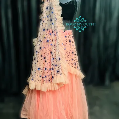 For a modern look at a reception or sangeet, I have this beautiful peach ruffled lehenga. The tiered skirt and embroidered dupatta create a contemporary silhouette.