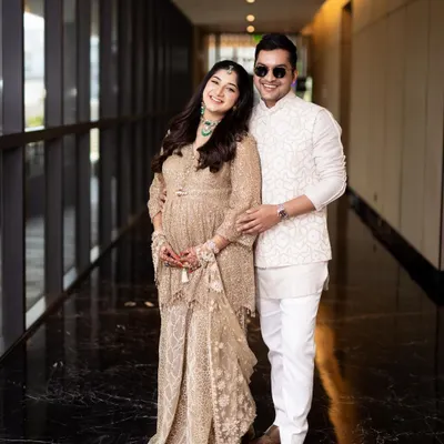 A beautiful portrait of the happy couple during their maternity celebration. Her makeup is soft and glowing, perfect for the occasion.