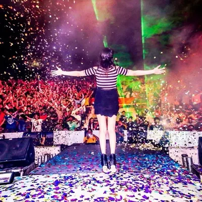 This is the moment it's all about. Standing on stage, connected with thousands of people through music, with confetti in the air. This is the pure joy and energy I bring to every performance.