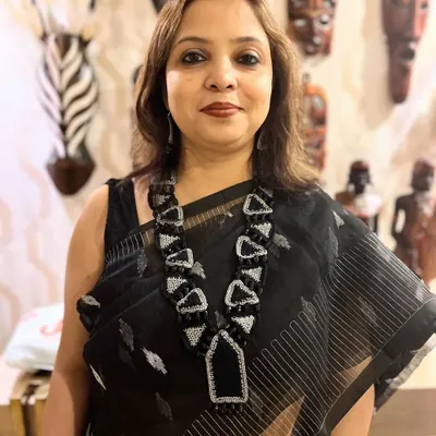 This custom-designed geometric necklace, seen here on a happy patron, is an example of our statement jewellery. We combine crochet with beads and zari to create unique, wearable art that complements your individual style.