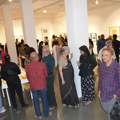 A wide shot of the bustling preview night for Gulammohammed Sheikh's 'Hand Prints'. My goal is to create a space where people feel welcome to gather, talk, and celebrate art.