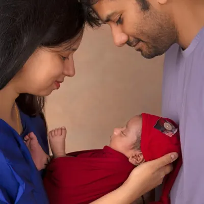 The three of you, together at last. This classic family pose captures the beginning of your new life, with your little one held securely in your loving arms.